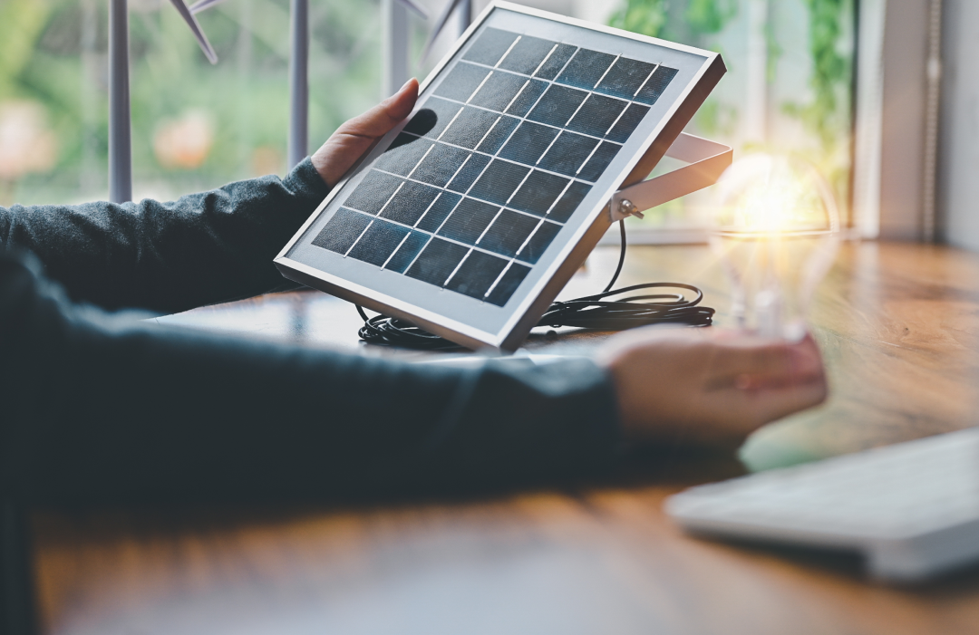 man holding a small solar panel